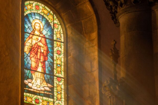 A stained glass window showing an image of Christ