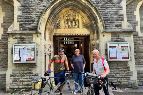 cyclists in front of church